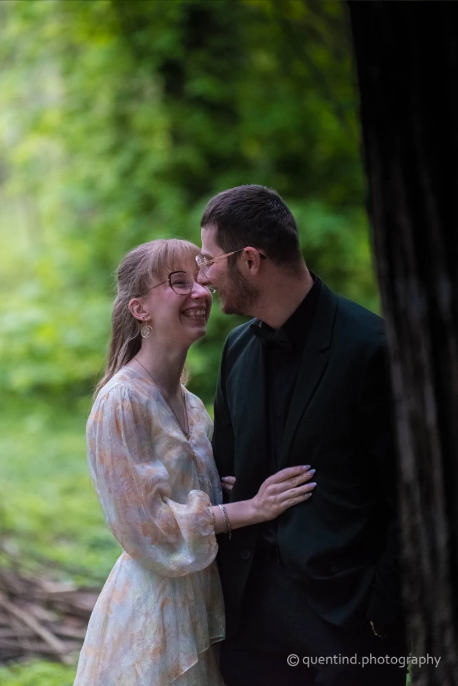 Portrait naturel de couple souriant dans un cadre verdoyant, mariage civil en Belgique